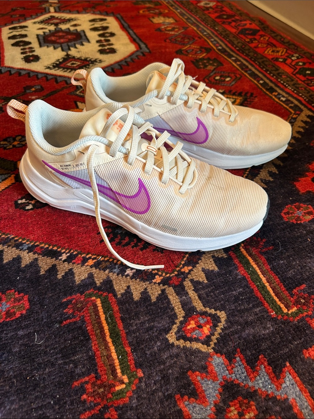 Nike Women’s Cream/White Sneakers with Purple Swoosh Accent